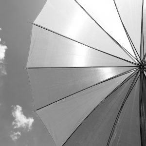 Underside of a large protective umbrella with the sky in the background