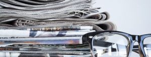Stack of newspapers reporting on unclaimed pension pots an dividend drought