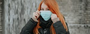 Young women wearing a face mask, the intergenerational impact of coronavirus