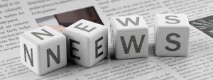 cubes spelling word news on top of newspapers
