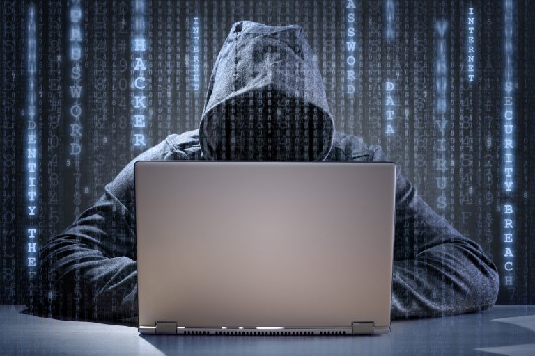 Computer hacker stealing data from a laptop, “It won’t happen to me” - think again