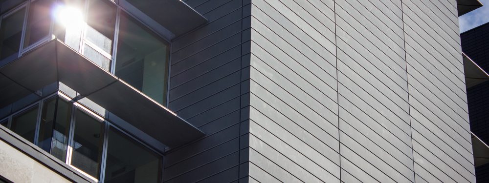 Exterior view of a modern office building with a sun shining