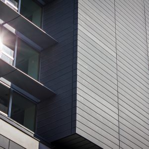 Exterior view of a modern office building with a sun shining