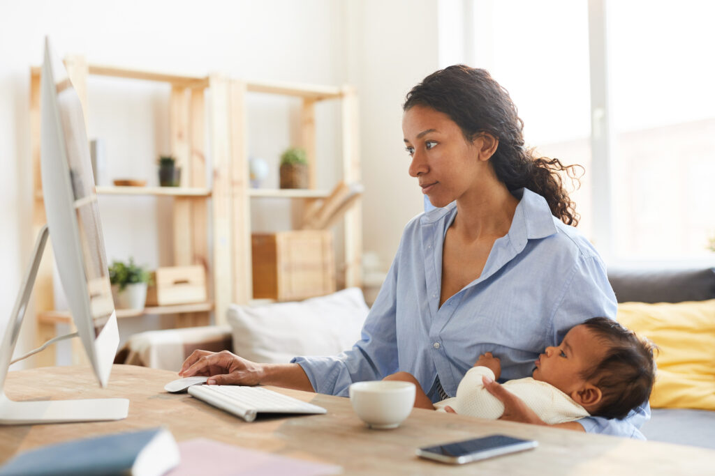 Mother looking on the computer for child pension options for her baby 