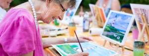 Mature lady painting considering dropping life insurance