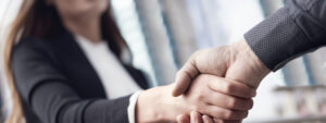 Businesswoman shaking hands with colleague