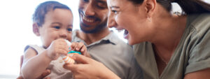 Mum and Dad with their baby, cost of raising children soars