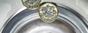 Coins falling into a sink, money in the news