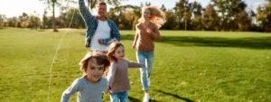 Family playing at the park with kites