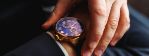 Businessman looking at his watch, waiting for the latest news