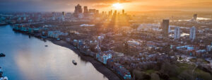 London, England - Panoramic aerial skyline view of east London at sunrise with skycrapers of Canary Wharf and beautiful colorful sky at background