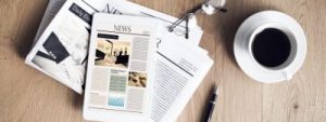 Financial news papers on a table, featuring contactless payments, new polymer notes and changes to LISA