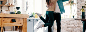 Optimistic couple dancing in the kitchen
