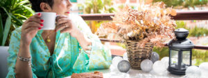 Lady drinking coffee thinking about investing