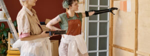 Two ladies decorating a house, homebuyers in new home