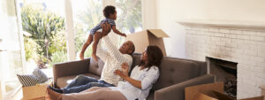 Parents Take A Break On Sofa With Son On Moving Day