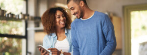 Shot of a happy young couple using a digital tablet while preparing a healthy meal together at home