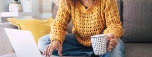 Lady sitting on her sofa looking at her laptop and information about Mortgage market makes ‘astonishing’ recovery