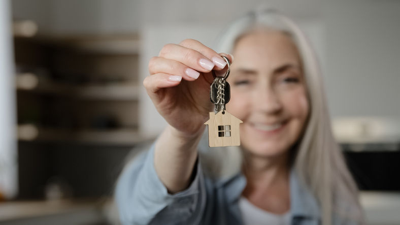 Old happy woman homeowner buyer female mature lady seller real estate agent tenant adult caucasian granny show bunch keys of accommodation house rental flat win new property apartment buy loan housing dwelling. High quality 4k footage
